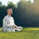 Shaolin monk meditating in the nature during sunrise... (thumbnail)