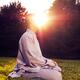 Sun rising behind a sitting meditating person... (thumbnail)