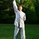 Person practicing sunrise Qi Gong in the nature... (thumbnail)