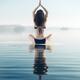 Back of a woman practicing yoga meditation on the water in sunrise mis... (thumbnail)