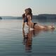 Woman practicing yoga in the water Upward Facing Dog posture... (thumbnail)