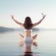 Woman practicing yoga meditation on the water with butterfly on her ha... (thumbnail)