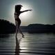 Woman dancing in moonlight under full moon on the water... (thumbnail)