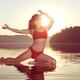 Woman practicing yoga on the water doing Pigeon pose in morning sunlig... (thumbnail)
