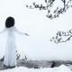 Woman standing on a cliff with spread hands embracing the world... (thumbnail)