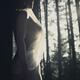 Beautiful artistic nude portrait of a woman in soft sunlight in forest... (thumbnail)