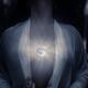 Woman with glowing Full Moon pendant on her chest