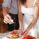 Couple preparing pancakes together in the kitchen... (thumbnail)