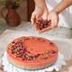 Woman decorating home made cake with flowers... (thumbnail)