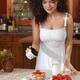 Young woman preparing pancakes in the kitchen... (thumbnail)