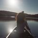Young woman canoeing on a lake lin sunlight... (thumbnail)