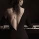 Sesual portrait of Woman in black dress with revealing low cut playing... (thumbnail)