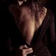 Sensual romantic portrait of a couple kissing in dim dramatic light... (thumbnail)