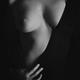 Artistic erotic closeup of woman breast in revealing black dress... (thumbnail)