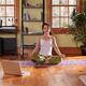 Young woman meditating at home in living room... (thumbnail)