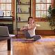 Woman doing yoga in living room... (thumbnail)
