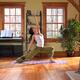 Young woman practicing yoga indoors on a sunny day... (thumbnail)