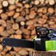 Electric Cordless Chainsaw by stacked firewood... (thumbnail)