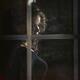 Woman face behind window glass... (thumbnail)