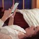 Woman reading book on iPhone 7... (thumbnail)