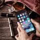 Woman hands with iPhone 7 with her purse and accessories... (thumbnail)