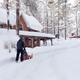 Man with snow thrower clearing driveway near house... (thumbnail)