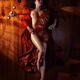 Beautiful nude woman covering her body with red fan... (thumbnail)