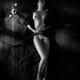 Beautiful nude woman with bamboo flute lying on floor Black and white... (thumbnail)