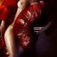 Beautiful naked woman body covered with red Asian fan... (thumbnail)