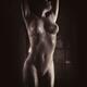 Beautiful nude woman body in dim dramatic light Black and white... (thumbnail)