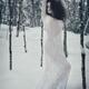 Woman in white lace dress in snowy winter nature scenery... (thumbnail)