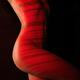 Nude woman body with red laser stripes skin rejuvenation concept... (thumbnail)