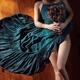 Sensual portrait of woman in blue dress with bare legs holding flowers... (thumbnail)