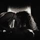 Sensual portrait of a couple making love in front of fireplace Black a... (thumbnail)
