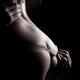 Sensual erotic closeup of man hands pulling underwear off woman... (thumbnail)