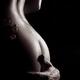 Sensual art nude closeup of woman body with man hand around her bottom... (thumbnail)