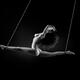 Beautiful nude woman suspended in a dynamic split by her ankles with b... (thumbnail)