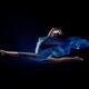 Beautiful woman making splits in the air with flowing blue cloth wrapp... (thumbnail)