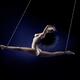 Beautiful nude woman flying suspended in splits by her ankles with bon... (thumbnail)