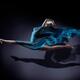 Surreal portrait of woman jumping with her legs in splits with flowing... (thumbnail)