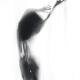 Beautiful graceful silhouette of a naked woman in glowing misty light... (thumbnail)
