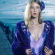 Young woman in blue dress and fur coat at waterfront... (thumbnail)