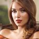 Portrait of a young woman with hair in a braid sitting in a chear... (thumbnail)