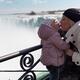 Mother Kissing her Little Daughter at Niagara Falls... (thumbnail)