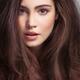 Beauty face portrait of a young woman with long brown hair and gray ey... (thumbnail)