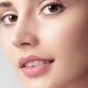 Closeup beauty portrait of young woman face with brown eyes... (thumbnail)