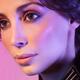 Closeup beauty portrait of woman face in colored purple light... (thumbnail)