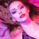 Beauty face portrait of woman lying in water with makeup in vivid pink... (thumbnail)