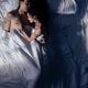Couple sleeping together in bed at night... (thumbnail)