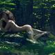 Beautiful naked woman lying nude on rocks in the nature... (thumbnail)